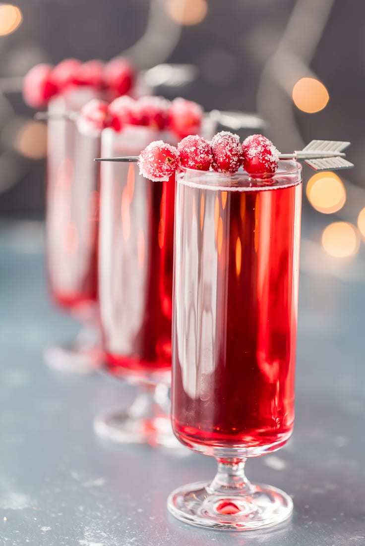 Sugared Cranberry Ginger Mimosas, ONLY THREE INGREDIENTS! Easy holiday cocktail recipe perfect for Thanksgiving, Christmas, and Valentine's Day! Pretty Red Cocktail!