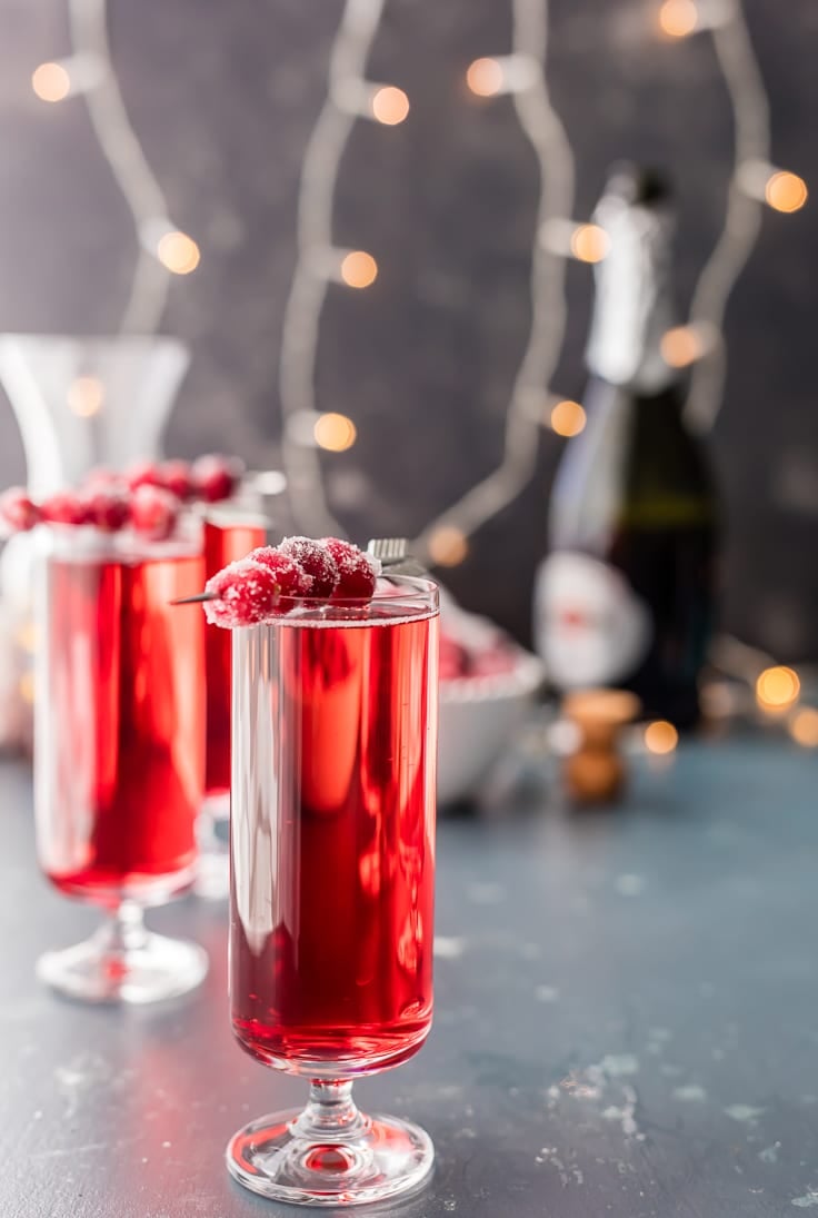 Cranberry Ginger Mimosas are the perfect holiday cocktail! Bubbly, tangy and only three ingredients! cranberry ginger mimosas with twinkle lights