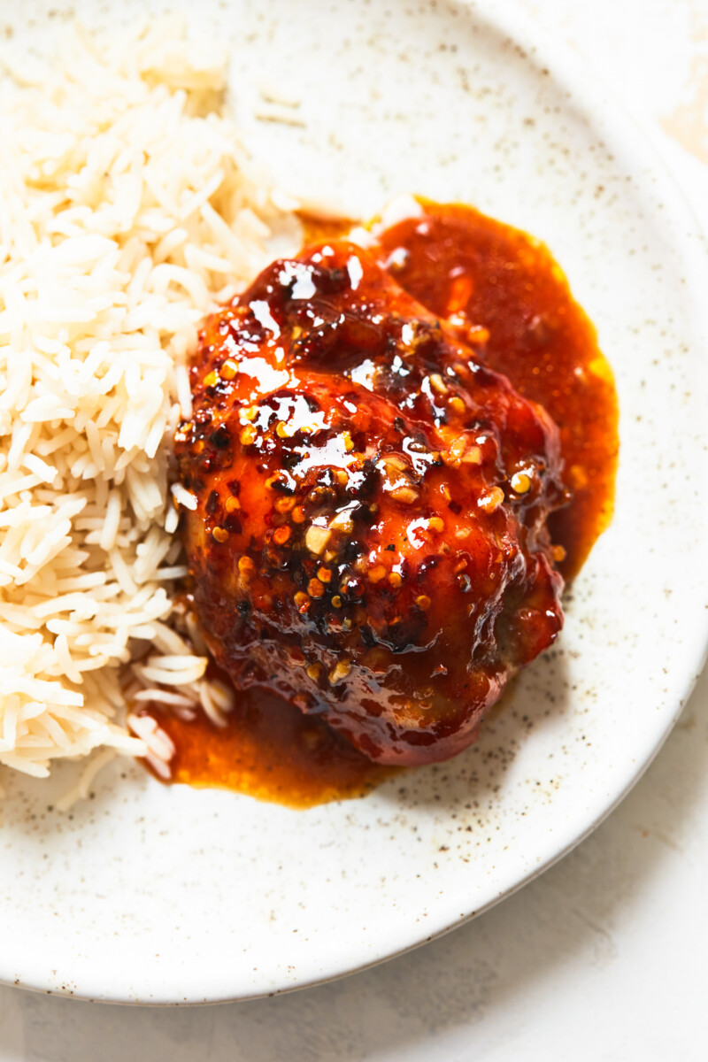 honey garlic chicken thigh with rice on plate