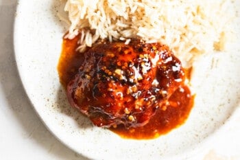 honey garlic chicken thigh with rice on plate