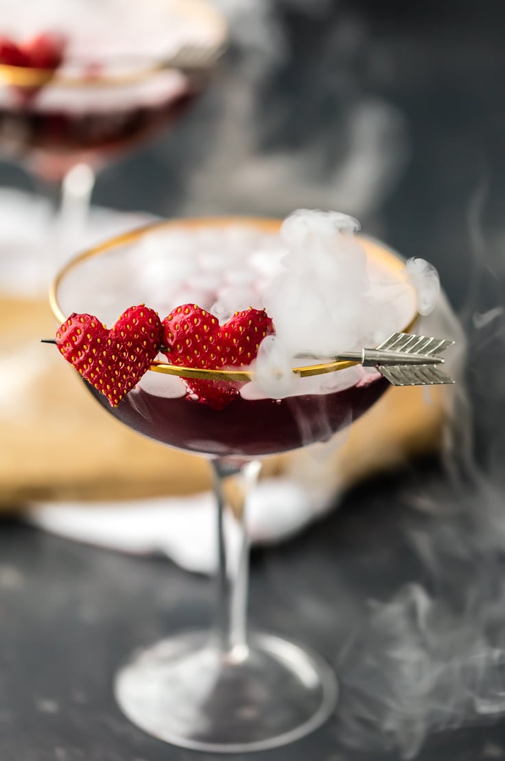 Valentine's Day drink in a glass with heart shaped strawberries as garnish