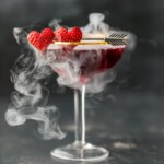 This Pomegranate Martini is the perfect Valentine's Day cocktail! It's a tasty triple berry martini with strawberry vodka, Chambord black raspberry liqueur, and pomegranate juice. Plus there's a little dry ice trick to really put on a show. It's one of my favorite Valentine's Day drinks!