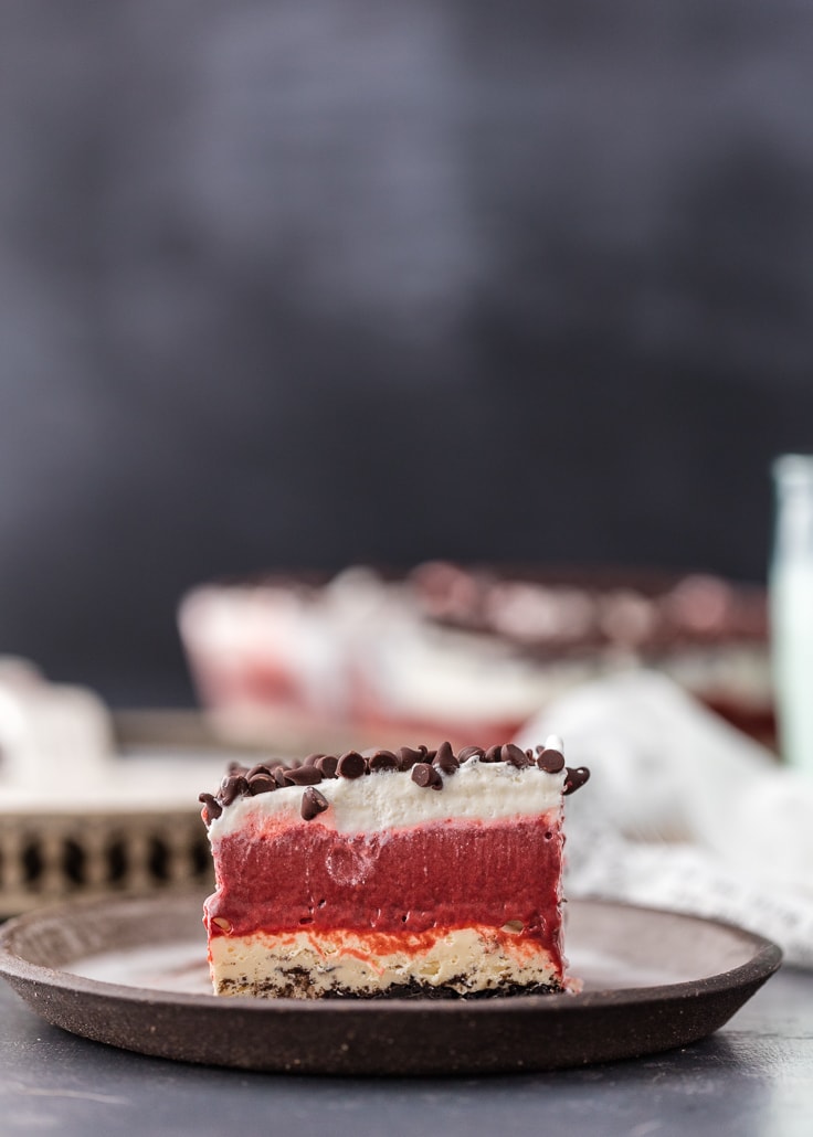 a piece of red velvet cheesecake lasagna on a plate