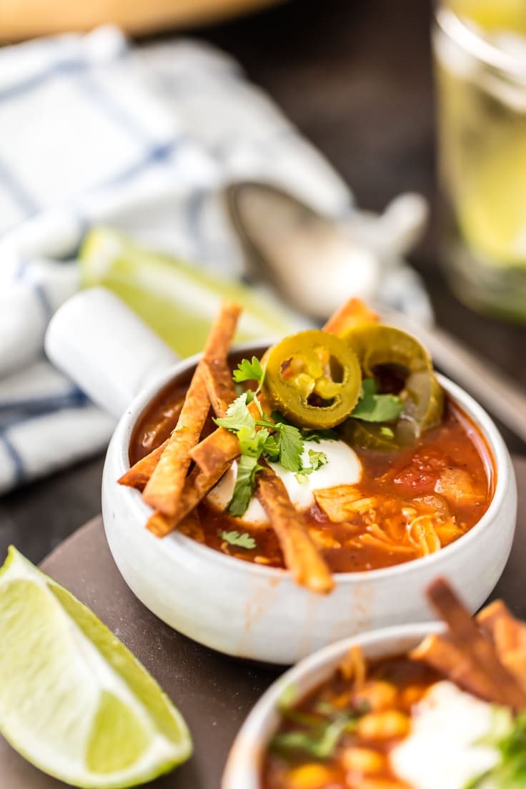 a bowl of slow cooker chicken tortilla soup. topped with fried tortilla strips
