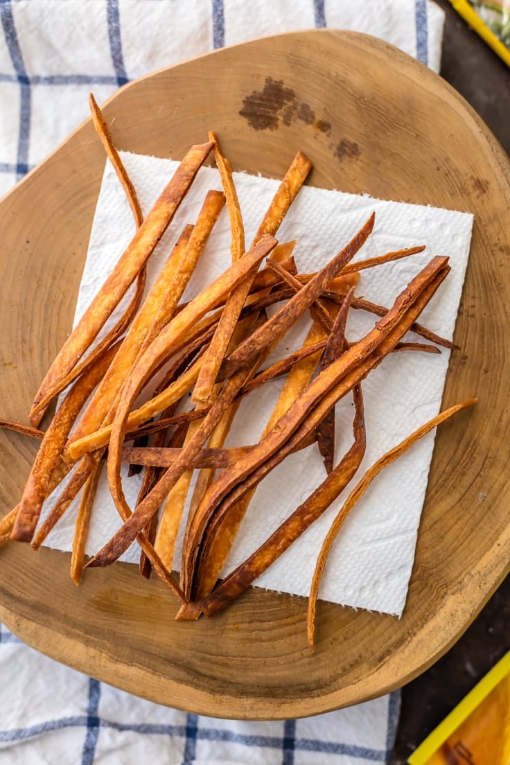 fried tortilla strips on a wood board