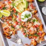 chicken nachos on a pan with two forks