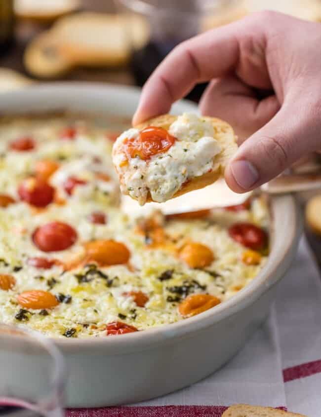 Garlic Herb Tomato Goat Cheese Dip is my FAVORITE EASY CHEESE DIP APPETIZER! Baked Goat Cheese Dip is classy, simple, and so delicious. Packed with tomatoes, garlic, feta, ricotta, and goat cheese. Go-to baked cheese appetizer.