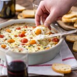 Goat Cheese Dip filled with cherry tomatoes, basil, garlic, and more is my FAVORITE EASY CHEESE DIP APPETIZER! It's classy, it's simple to make, and it's so delicious. Serve this baked cheese dip hot with some crostini, toasted bread, or hearty crackers.
