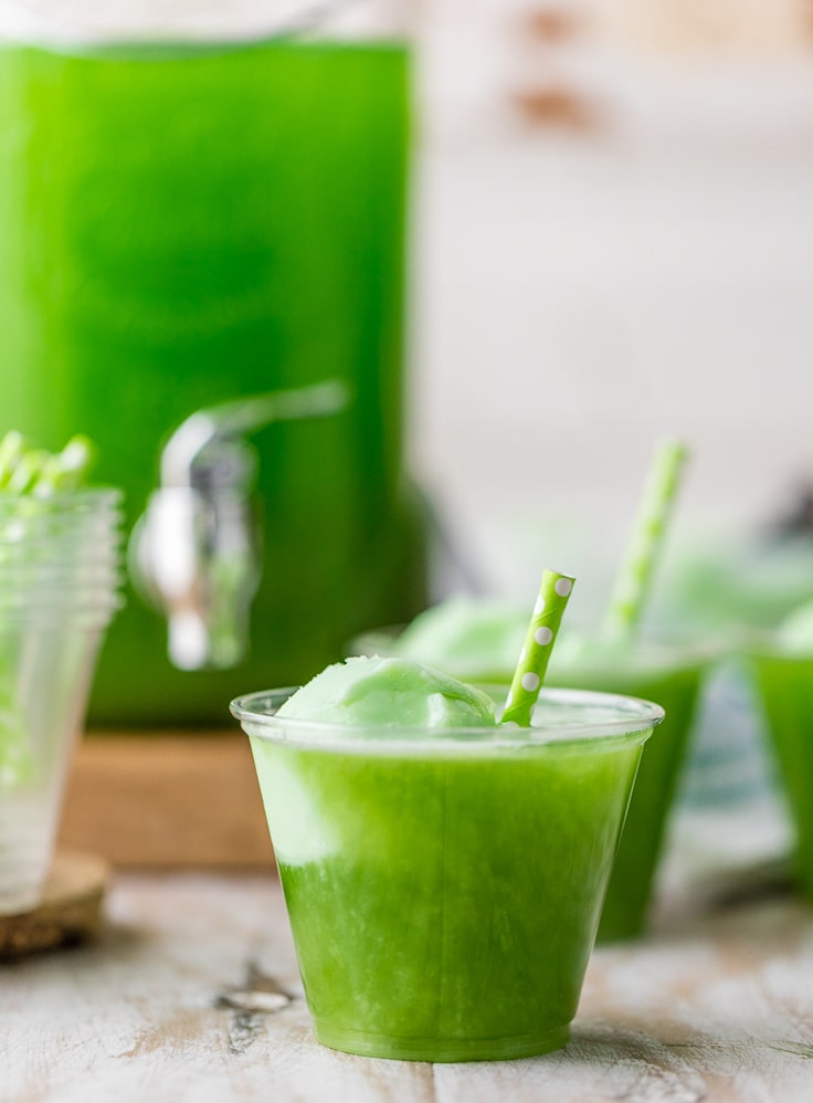 plastic cups filled with green sherbet punch