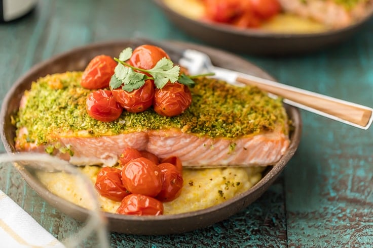 a plate of herb crusted salmon and goat cheese polenta