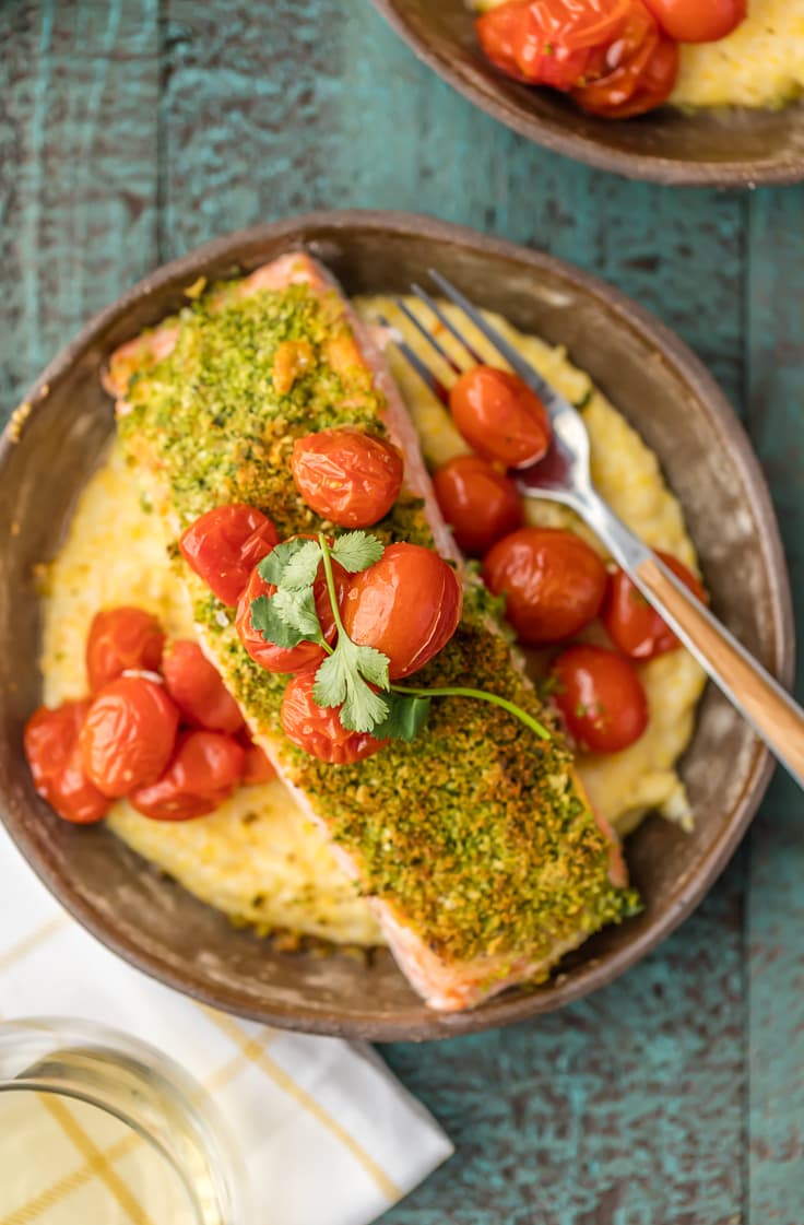 a bowl of goat cheese polenta with herb crusted salmon fillet