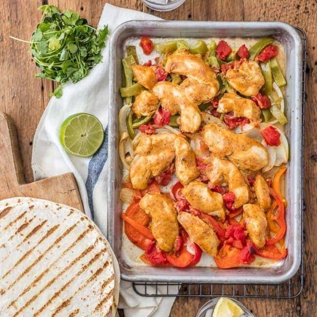 Sheet Pan Chicken Fajitas are one of our favorite healthy dinners! These baked chicken fajitas are lighter in calories and fat, but still packed with flavor. These healthy chicken fajitas are an easy sheet pan fajitas recipe that everyone will love. It's the perfect dinner for two!