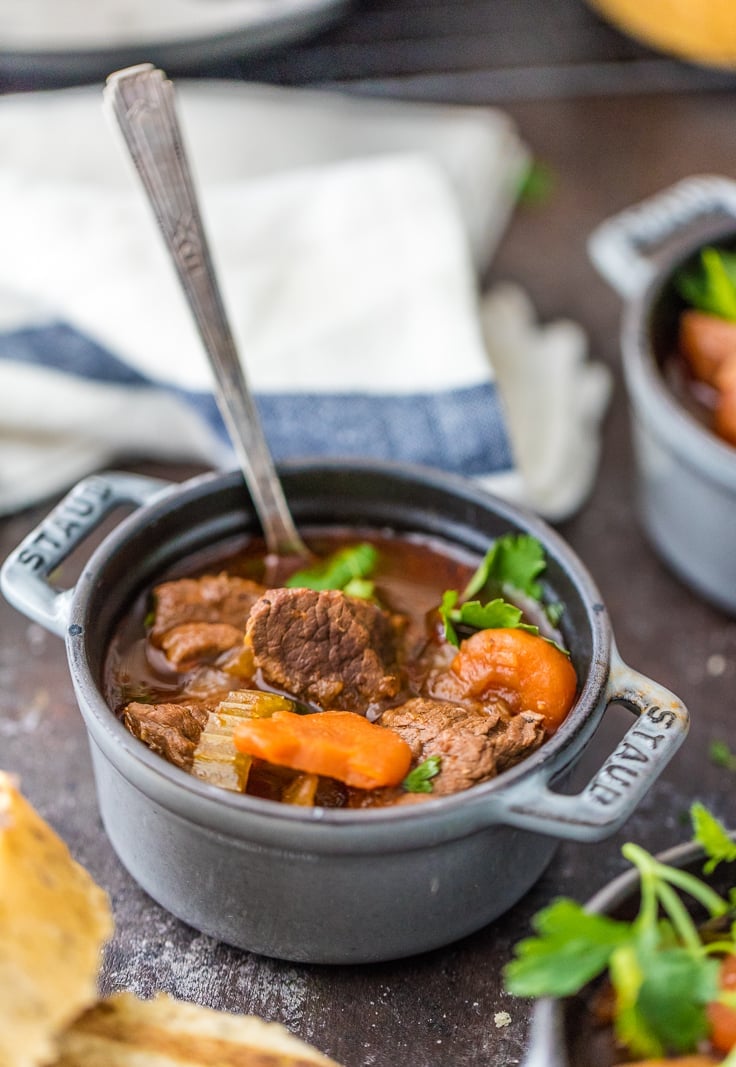 Guinness Beef Stew is a favorite Irish beef stew recipe in our house. We make this slow cooker beef stew for St. Patrick's Day every year, and we just can't get enough! It's the best Guinness stew and so easy to make! guinness stew in a cast iron bowl