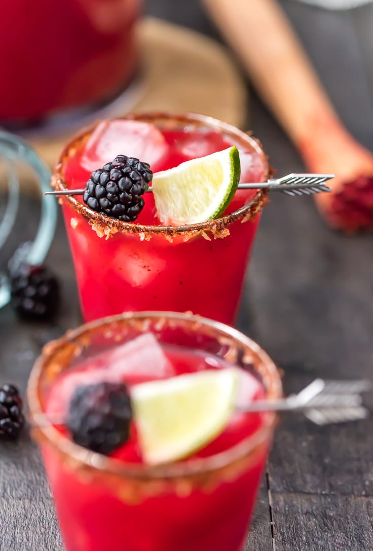 These Spicy Blackberry Margaritas for a crowd are THE BEST margaritas ever! Tequila, blackberry brandy, green chiles, fresh fruit, agave, orange juice, and lime. Rimmed with chili salt. Cheers! From The Cookie Rookie