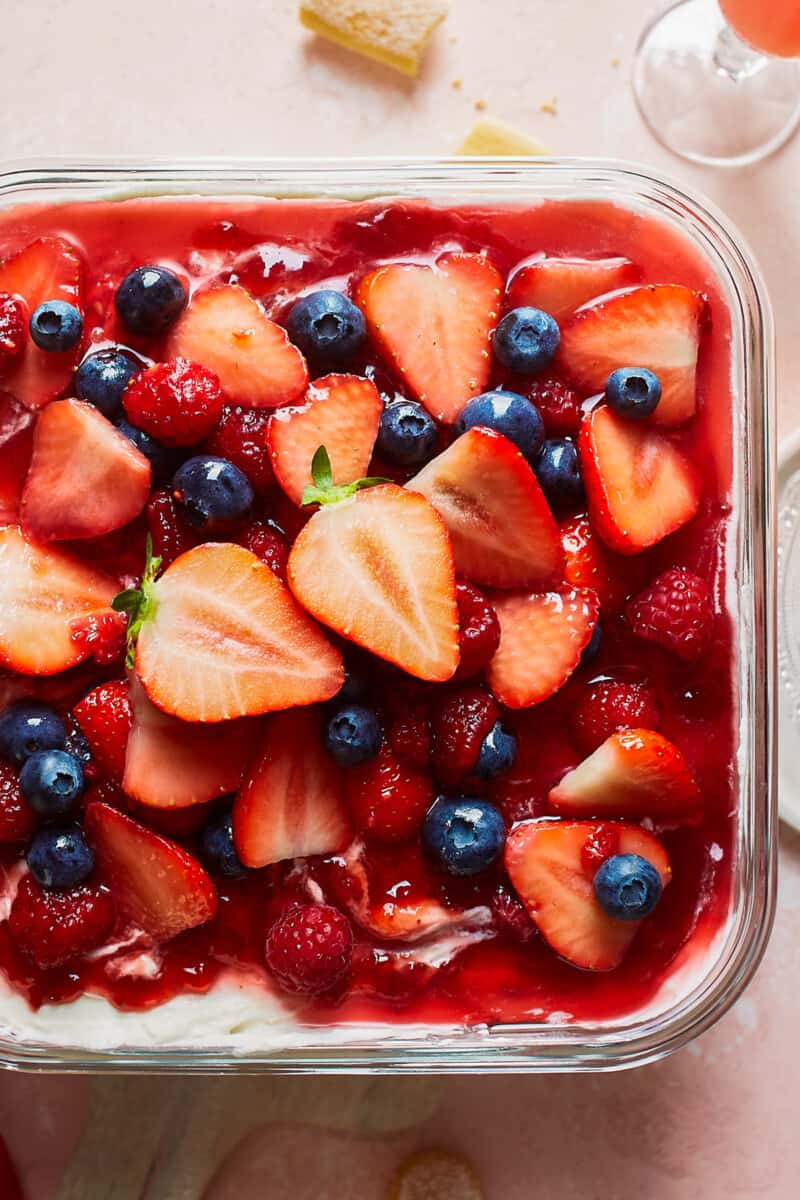 Strawberry Tiramisu with Blueberries and Raspberries is a delicious triple berry dessert! This fruity tiramisu recipe is sweet, beautiful, easy, and SO delicious. It's the perfect easy dessert recipe for Valentine's Day, 4th of July, or any other day of the year! overhead tiramisu with strawberries, blueberries, and raspberries