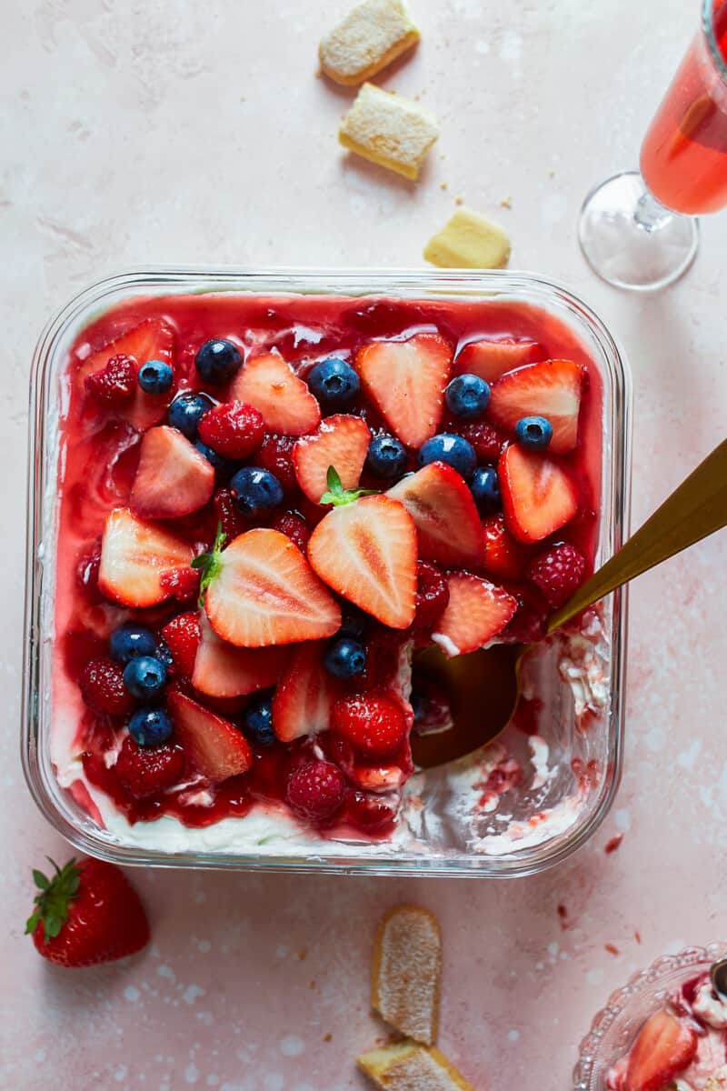 Strawberry Tiramisu with Blueberries and Raspberries is a delicious triple berry dessert! This fruity tiramisu recipe is sweet, beautiful, easy, and SO delicious. It's the perfect easy dessert recipe for Valentine's Day, 4th of July, or any other day of the year! triple berry tiramisu in pan