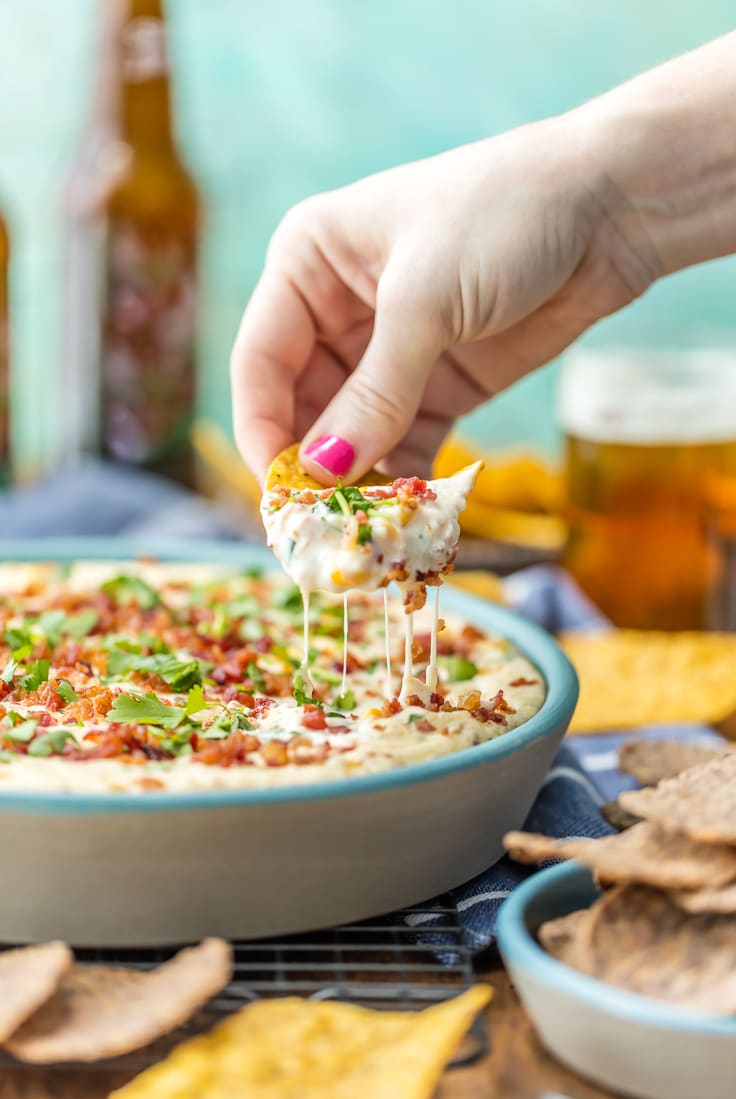 hand scooping up dip with chip