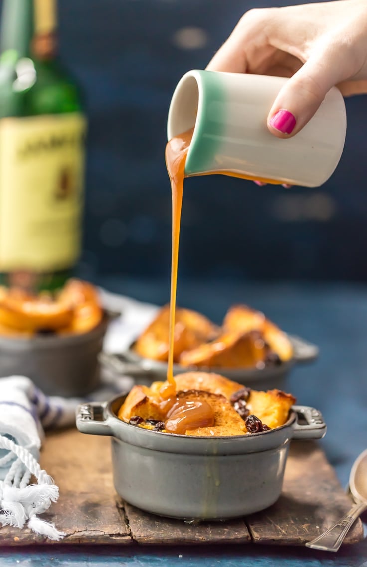 pouring whiskey sauce on top of bread pudding