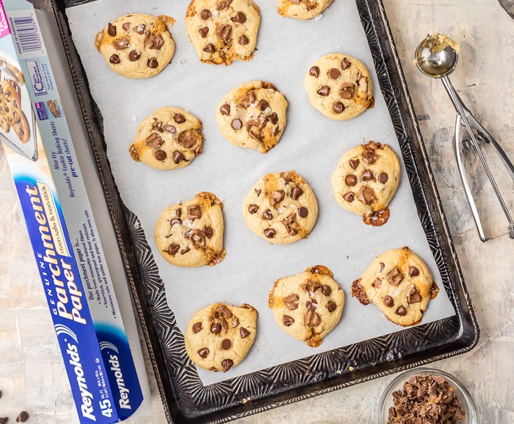 cookies on sheet with parchment paper and cookie scoop