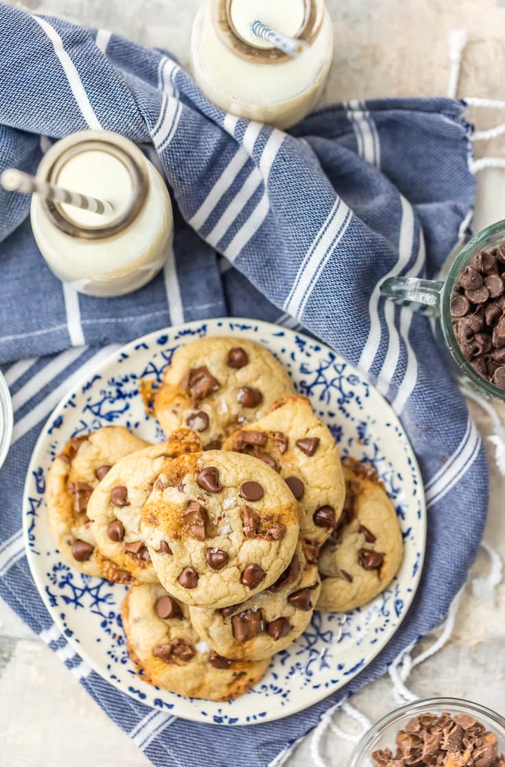 cookies on a plate with glasses of milk