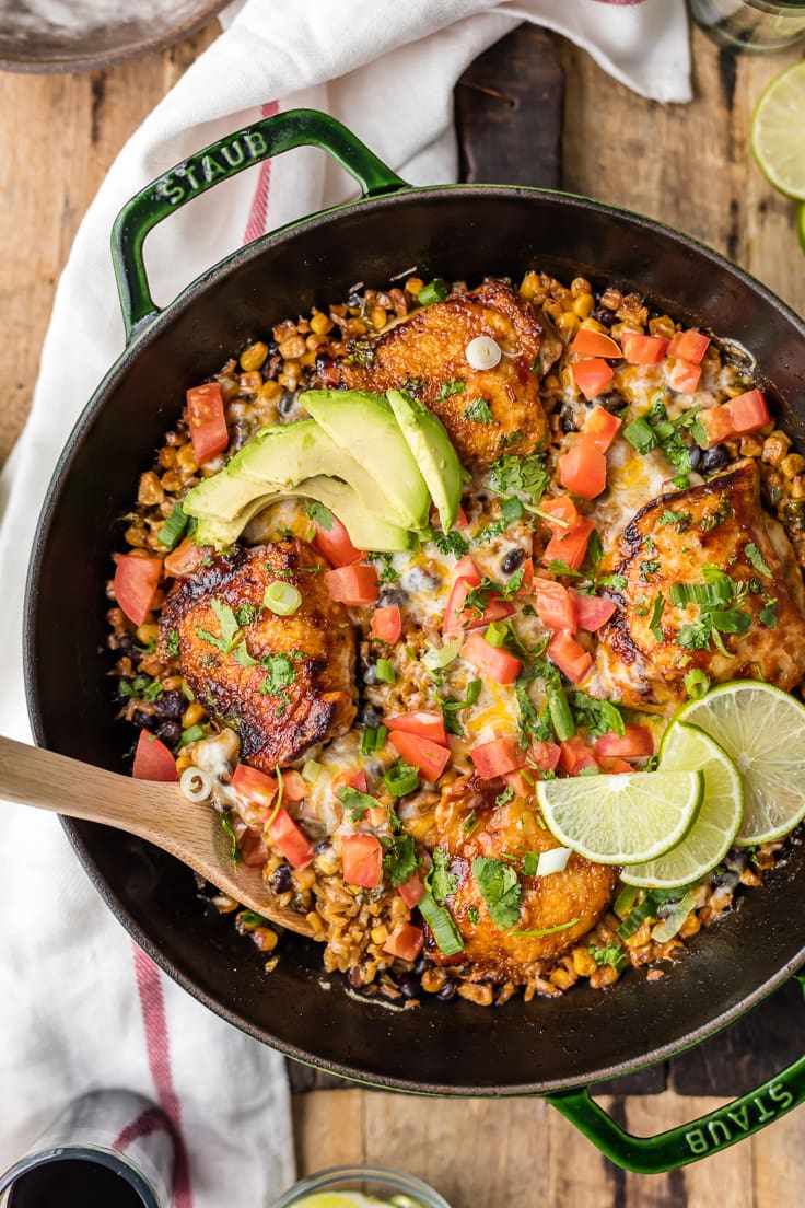 spoon in skillet with chicken and rice