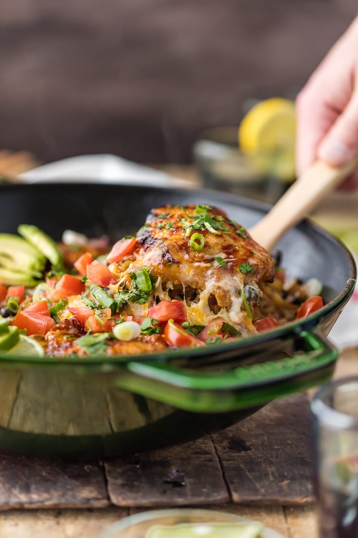 spoon lifting out chicken breast from skillet