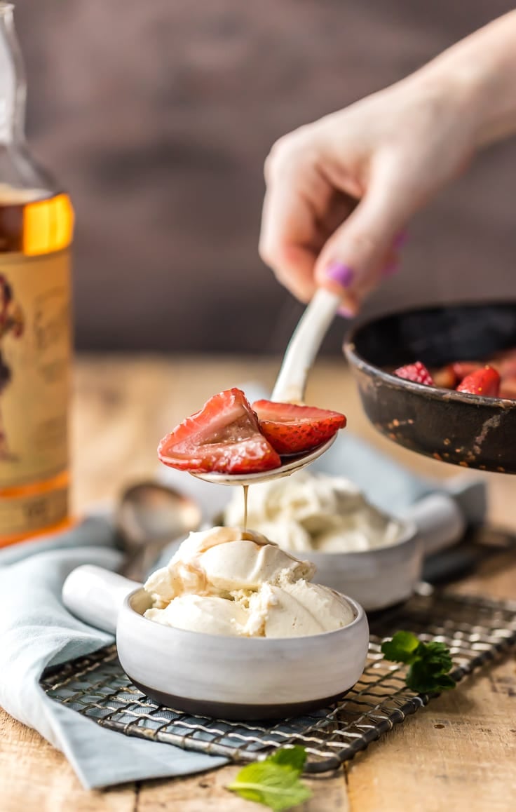 strawberries fosters being poured on ice cream