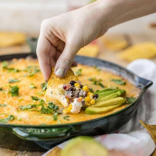 Who says 7 Layer Dip has to be cold? HOT 7 LAYER DIP SKILLET is the perfect tailgating dip for Cinco de Mayo! My favorite dip made in a skillet. YUM!