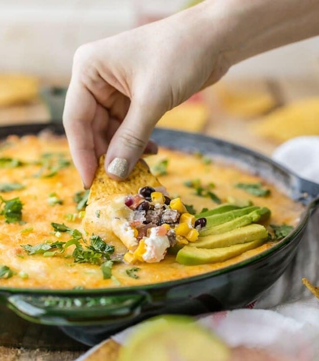 Who says 7 Layer Dip has to be cold? HOT 7 LAYER DIP SKILLET is the perfect tailgating dip for Cinco de Mayo! My favorite dip made in a skillet. YUM!