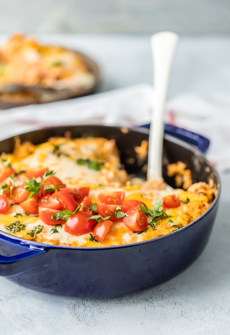 blue casserole dish with cheese and peppers