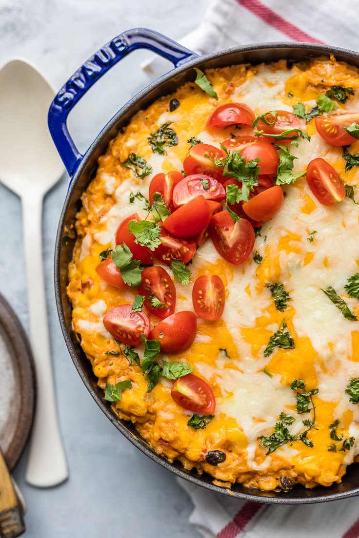 stuffed pepper casserole topped with cheese, tomatoes, and more