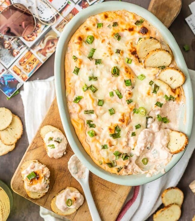 HOT SHRIMP COCKTAIL DIP is the best party appetizer ever! A hot cheesy version of an old favorite; with cocktail sauce, shrimp, cream cheese, sour cream, mozzarella, and green onion! AMAZING!