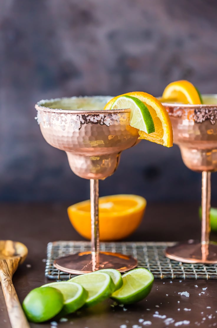 two margaritas against a dark backdrop