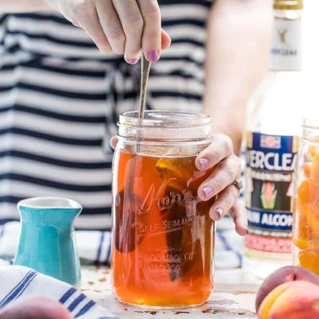 Homemade Peach Tea Vodka is an easy and fun DIY liqueur. Easily made by infusing Everclear with peaches and black tea, the perfect mixer for so many Summer cocktails!