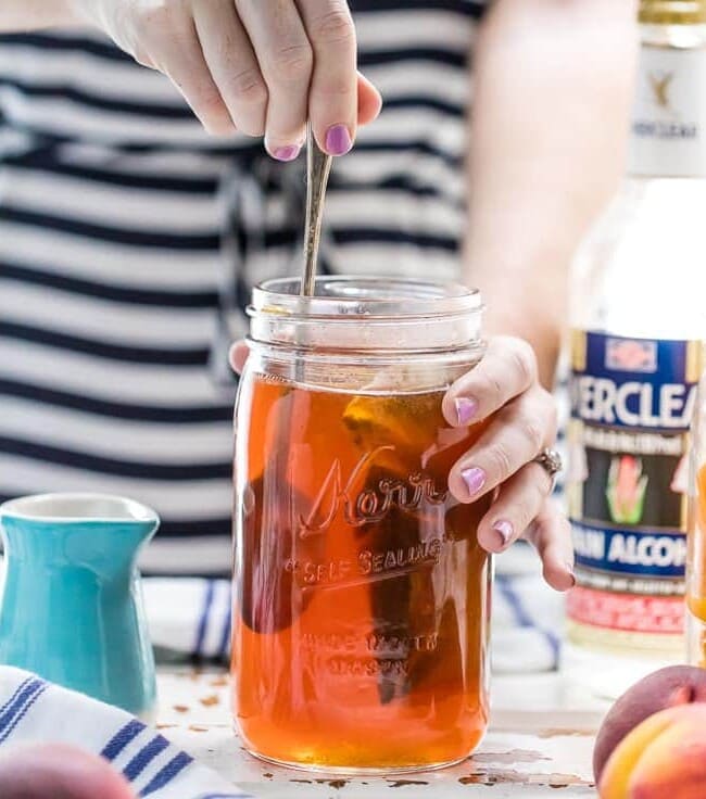 Homemade Peach Tea Vodka is an easy and fun DIY liqueur. Easily made by infusing Everclear with peaches and black tea, the perfect mixer for so many Summer cocktails!