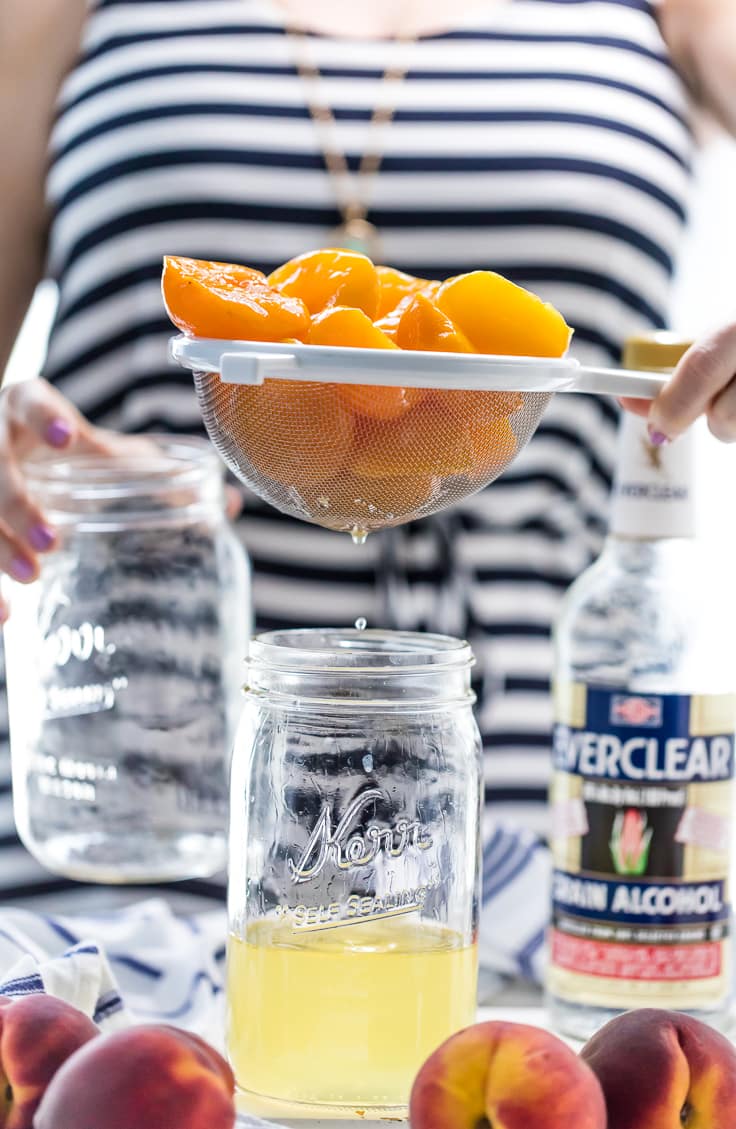 holding peaches over a mason jar