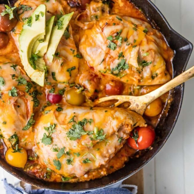 This ONE PAN ENCHILADA STUFFED CHICKEN SKILLET (Or Inside Out Chicken Enchiladas) are a family favorite! Chicken stuffed with rice, enchilada sauce, cream cheese, tomatoes, and more cheese! You've never had a meal this good!