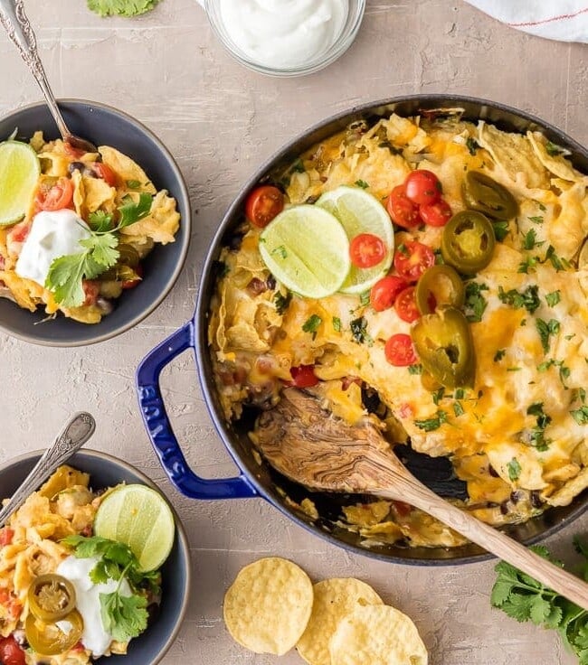 SUPER EASY CHICKEN NACHO CASSEROLE is our favorite Mexican weeknight meal! Throw it together, bake, and enjoy this cheesy, spicy, delicious, EASY Tex Mex meal in just minutes! Layered with chips, cheese, chicken, rotel, and more!