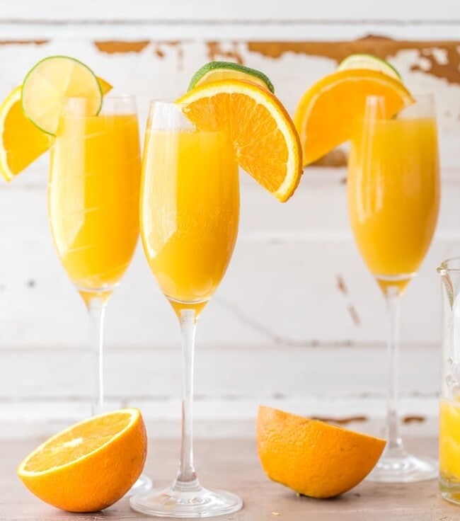 Moscow Mule Mimosas make for the BEST BRUNCH EVER! So easy, unique, delicious, and fun! Spiked ginger beer, orange juice, and champagne! YUM!