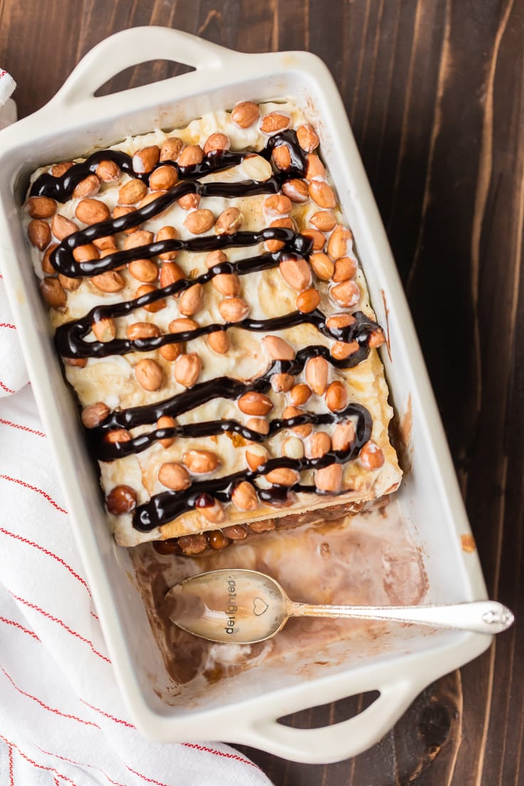 homemade ice cream cake topped with peanuts and fudge