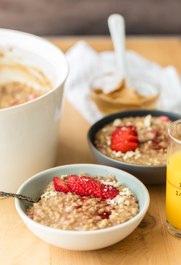 bowls of steel cut oatmeal topped with strawberries and peanuts