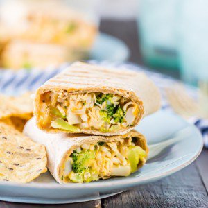 burrito cut in half stacked on each other on a white plate