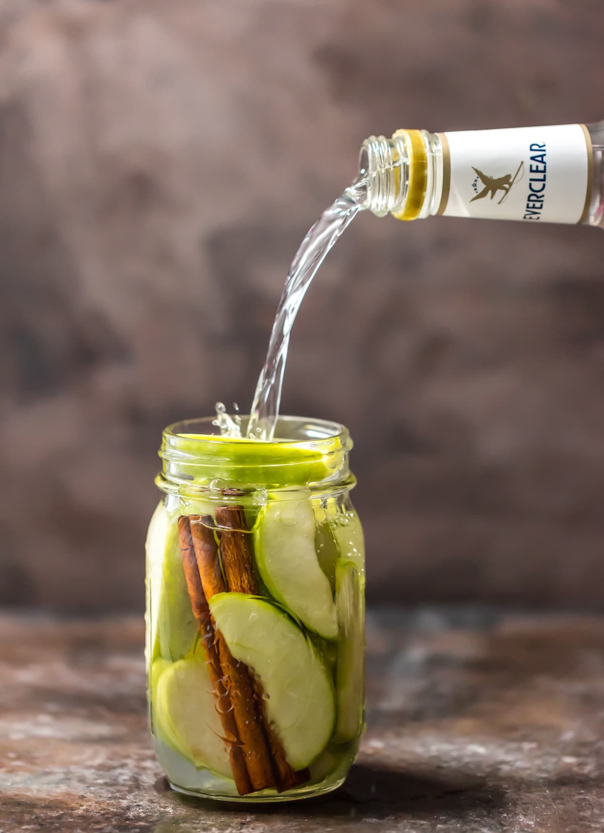 A mason jar filled with apple pie vodka