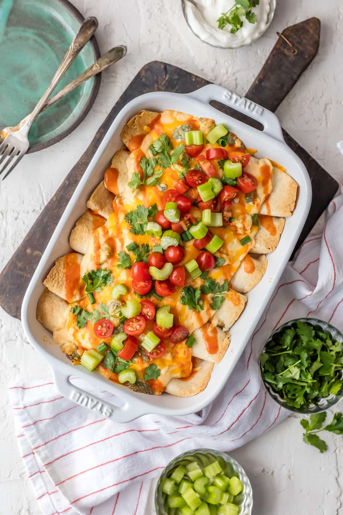 Creamy Buffalo Chicken Enchiladas in a baking dish