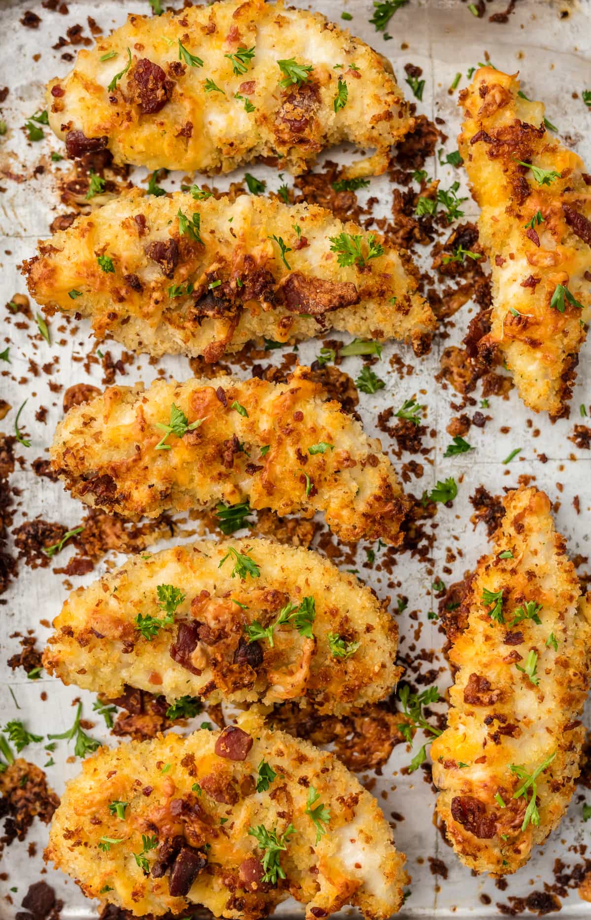 CHEDDAR BACON RANCH CHICKEN TENDERS! These Baked Chicken Strips are SO CRISPY, flavorful, and delicious. Coated in ranch, cheese, and bacon, and baked to perfection. Dip in extra ranch for the perfect snack!