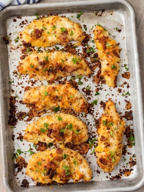 Baked Chicken Tenders are SO CRISPY, so flavorful, and so delicious. These Cheddar Bacon Ranch Chicken Strips are a new favorite for game day! They're coated in ranch, cheese, and bacon, and oven baked to perfection.