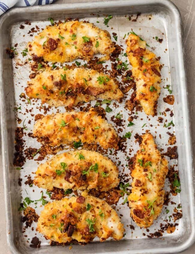 Baked Chicken Tenders are SO CRISPY, so flavorful, and so delicious. These Cheddar Bacon Ranch Chicken Strips are a new favorite for game day! They're coated in ranch, cheese, and bacon, and oven baked to perfection.