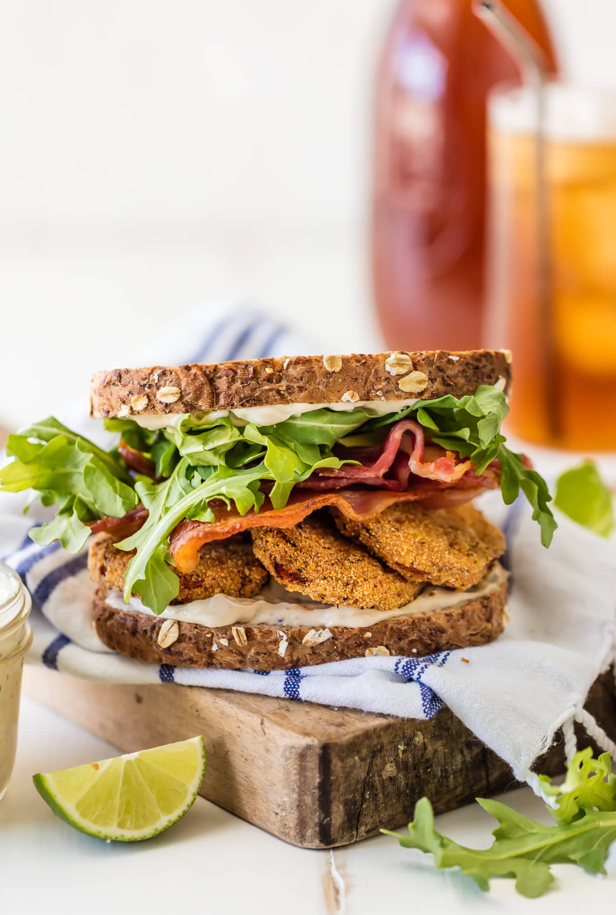 A BLT sandwich made with fried tomatoes and arugula 