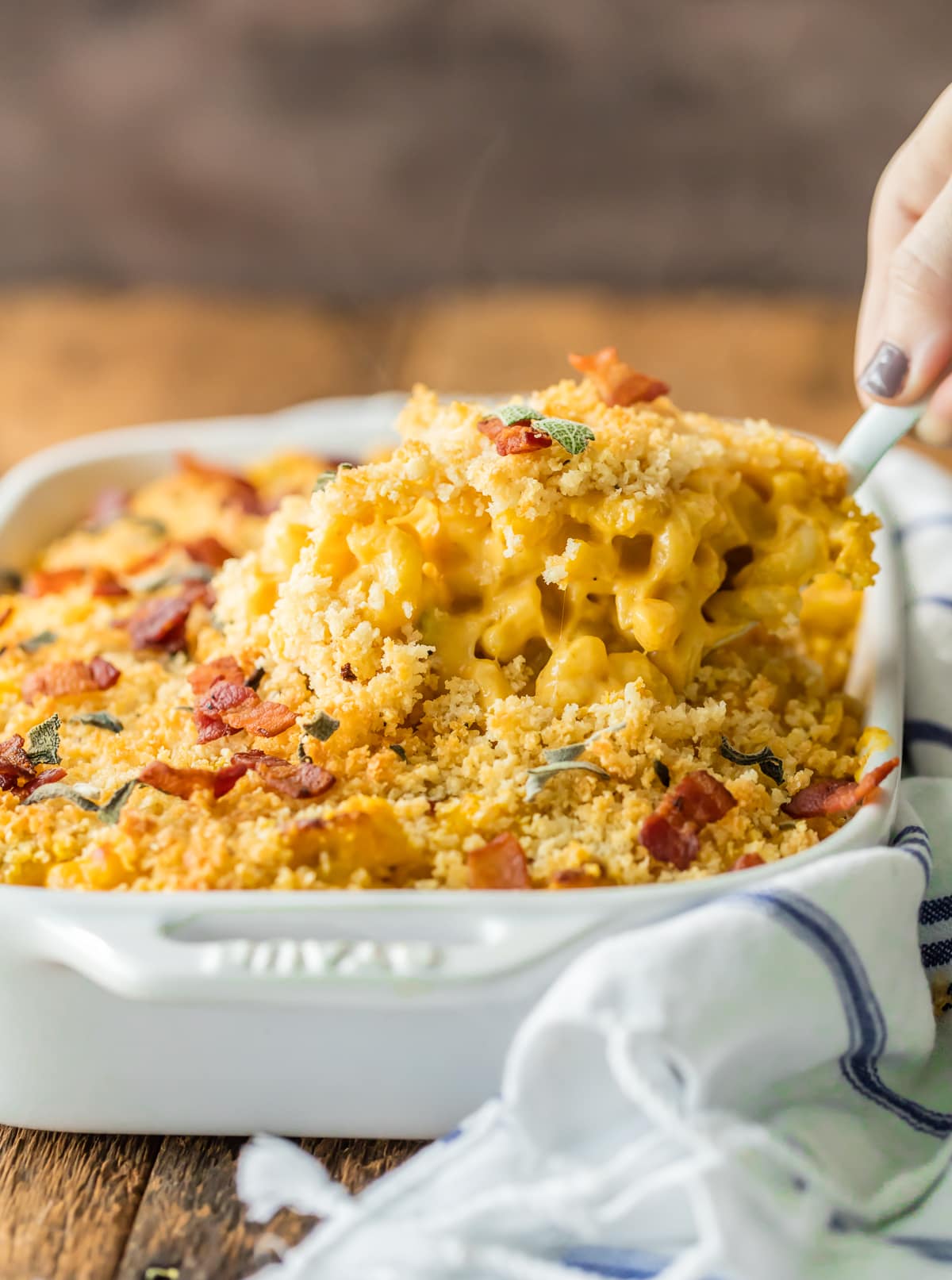 Baked Pumpkin Bacon Mac and Cheese is the ULTIMATE comfort food for Fall! Autumn in a casserole dish! Loaded with cheese, bacon, pumpkin, sage, and more cheese. BEST MACARONI AND CHEESE EVER!