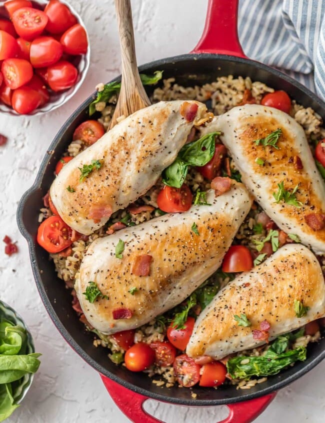 This BLT Chicken and Rice Skillet is the perfect one pan meal to feed the whole family! It's loaded with garlic, chicken, bacon, tomatoes, spinach, and a brown rice & quinoa mix! This chicken and rice recipe is totally delicious and SO EASY!